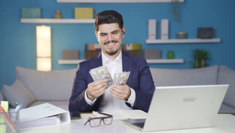 Happy-male-employee-earning-money-smiling-at-camera.